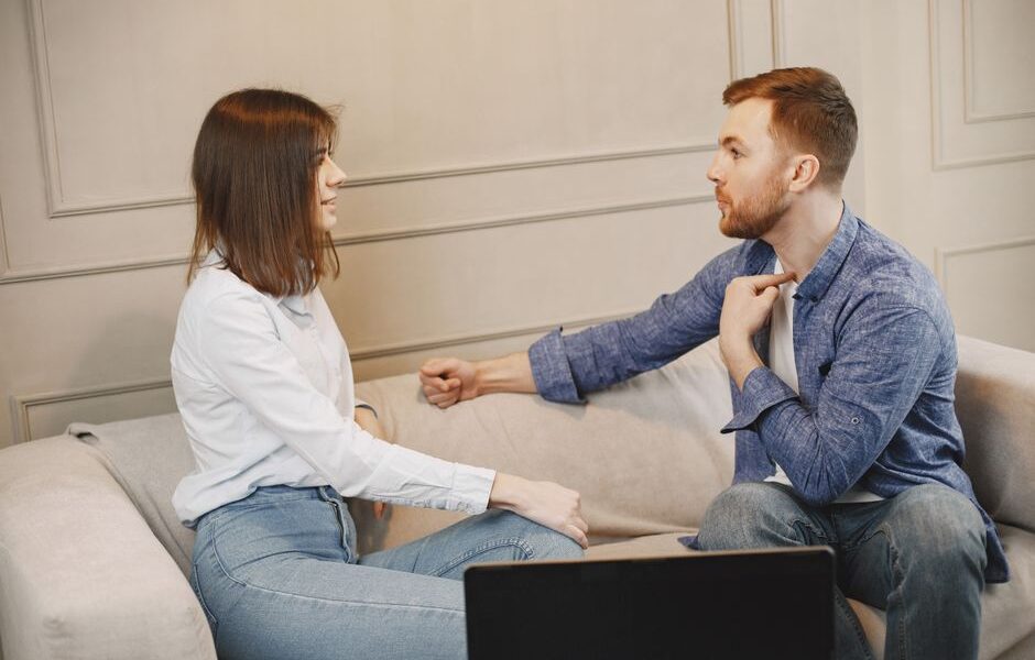 Kobieta i mężczyzna siedzący na kanapie podczas rozmowy